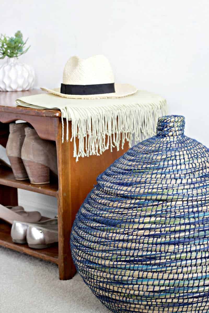 A orderly room with pajamas hidden in a lidded basket