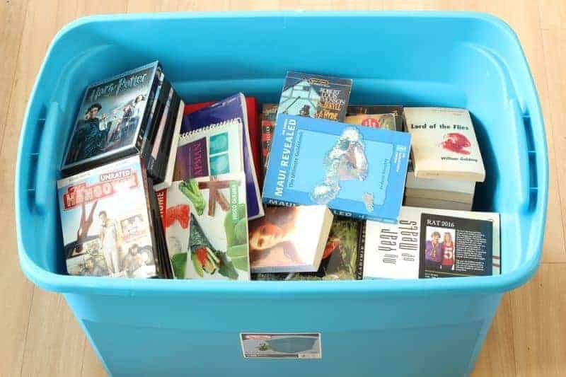 A bin full of books and DVDs for Decluttr