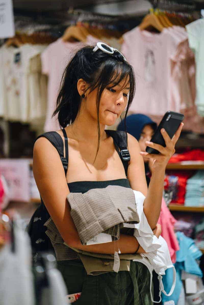 Girl thrift shopping with eBay