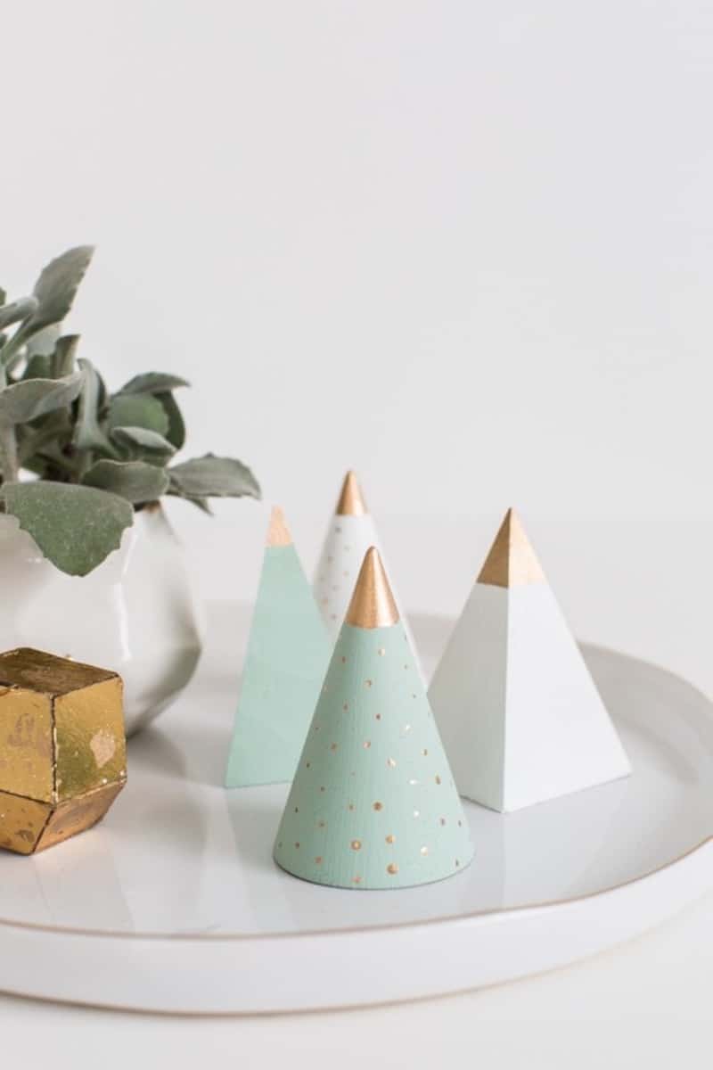 Three wooden minimalist Christmas trees on a platter