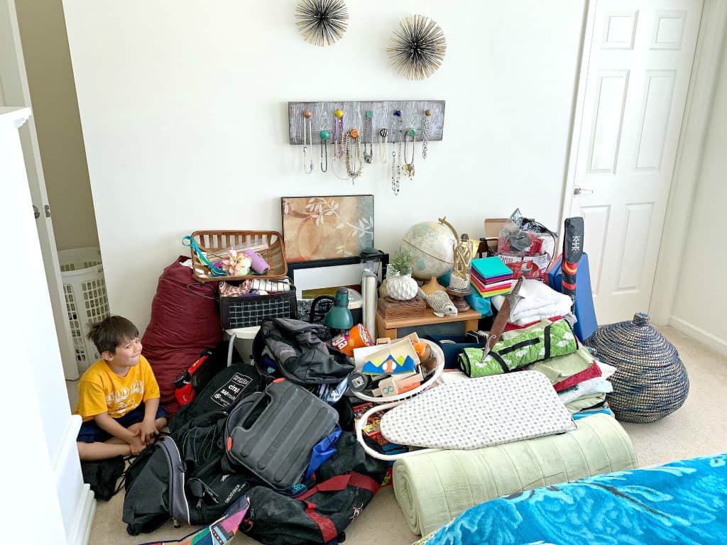 Picture of extreme decluttering a bedroom full of stuff.