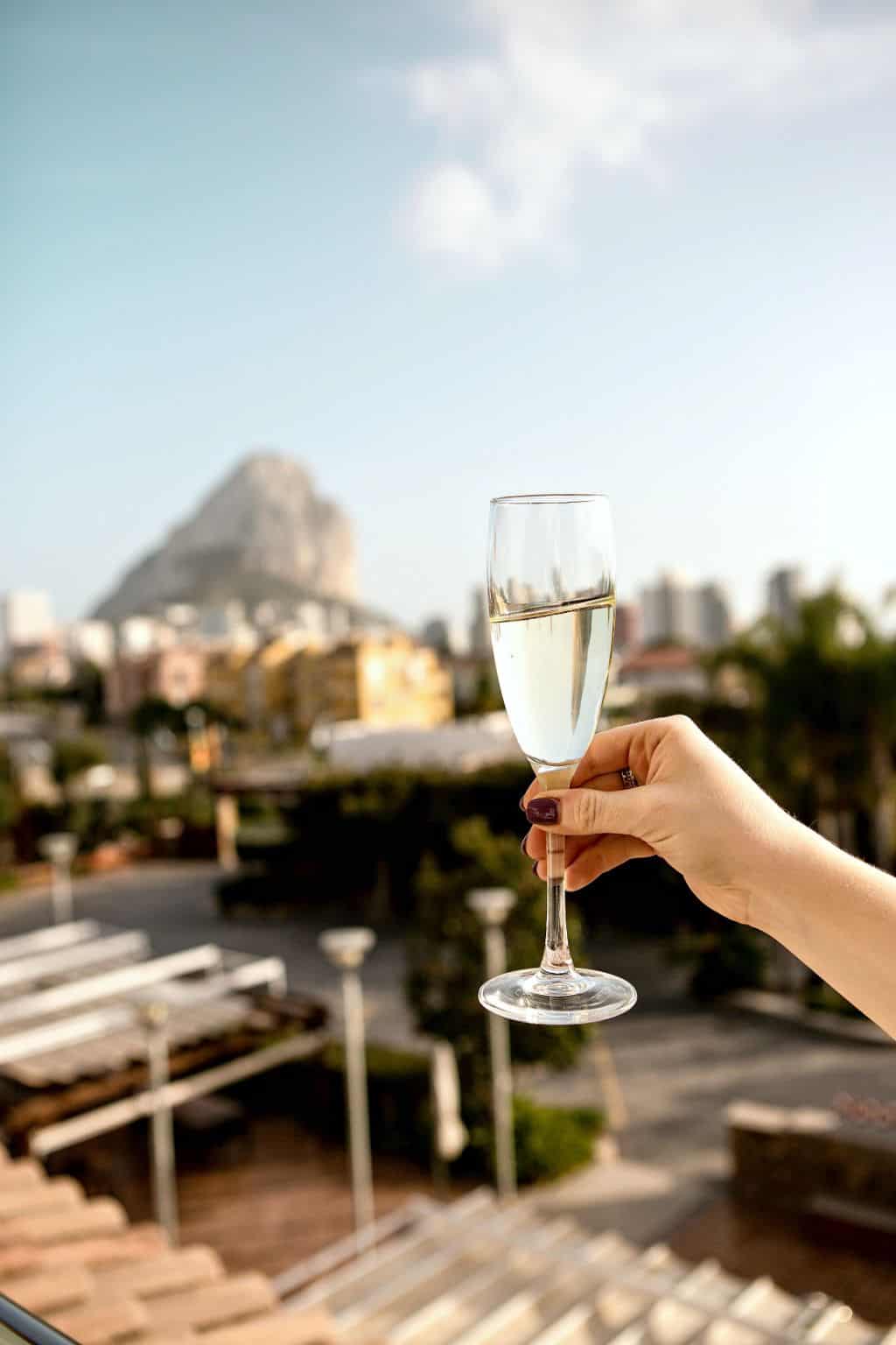 A woman making a toast to celebrate paying off debt