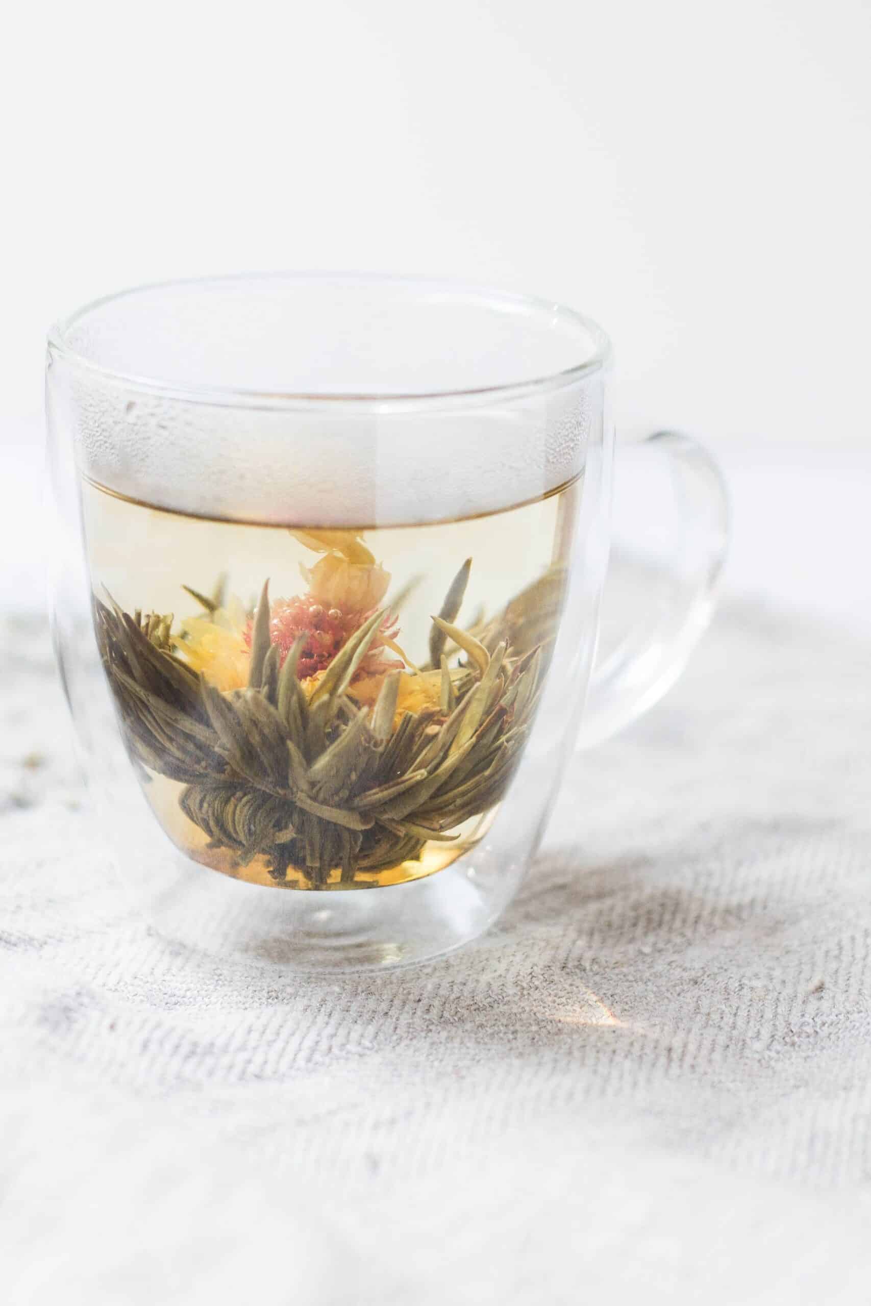 A small cup of blooming tea on a table