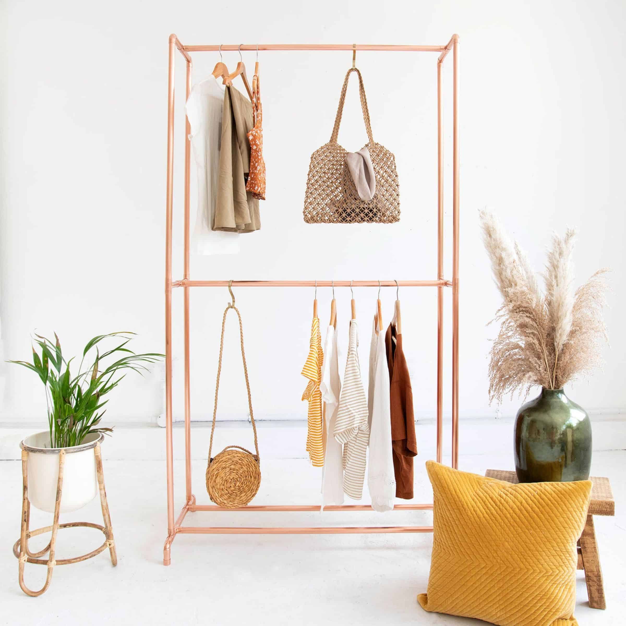 A minimalist double copper capsule wardrobe rack