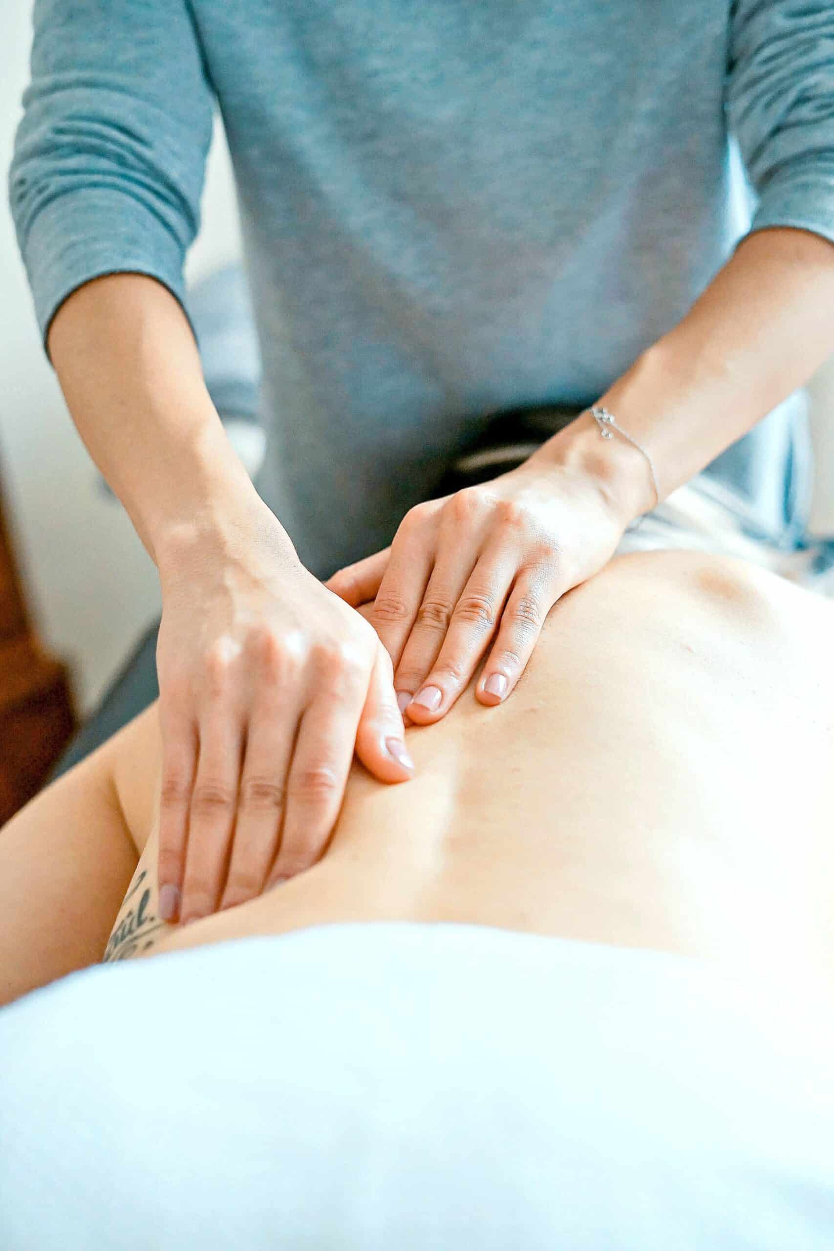 A woman giving someone a back massage as a Christmas gift