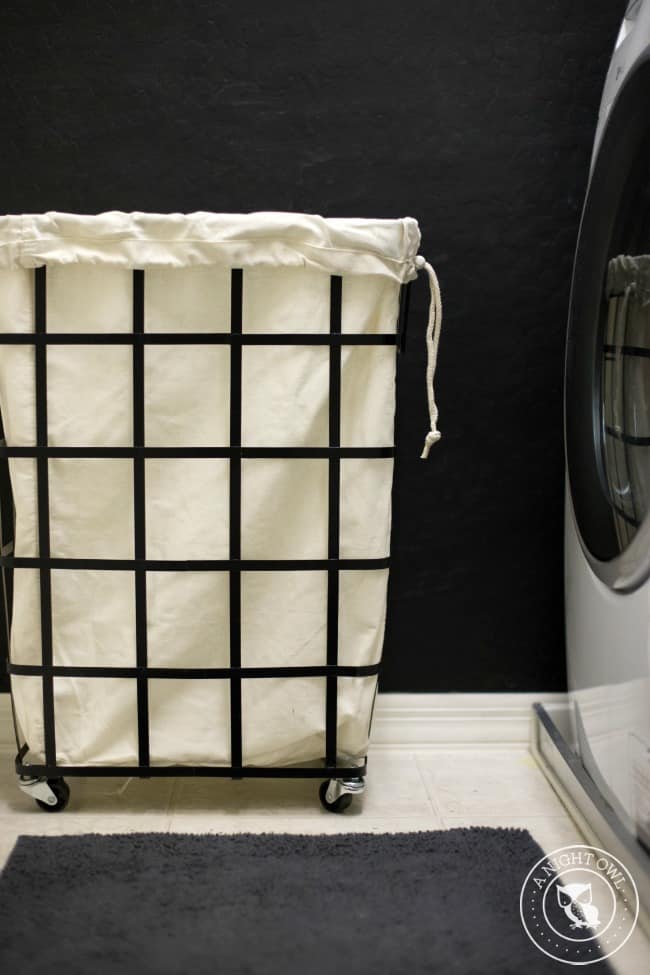 A laundry basket with wheels in a laundry room