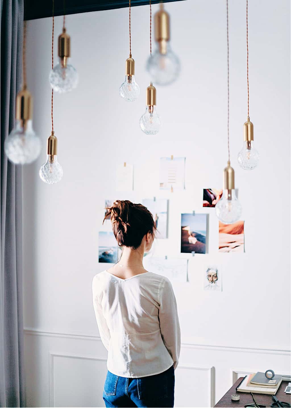 A woman looking at a vision board ideas wall