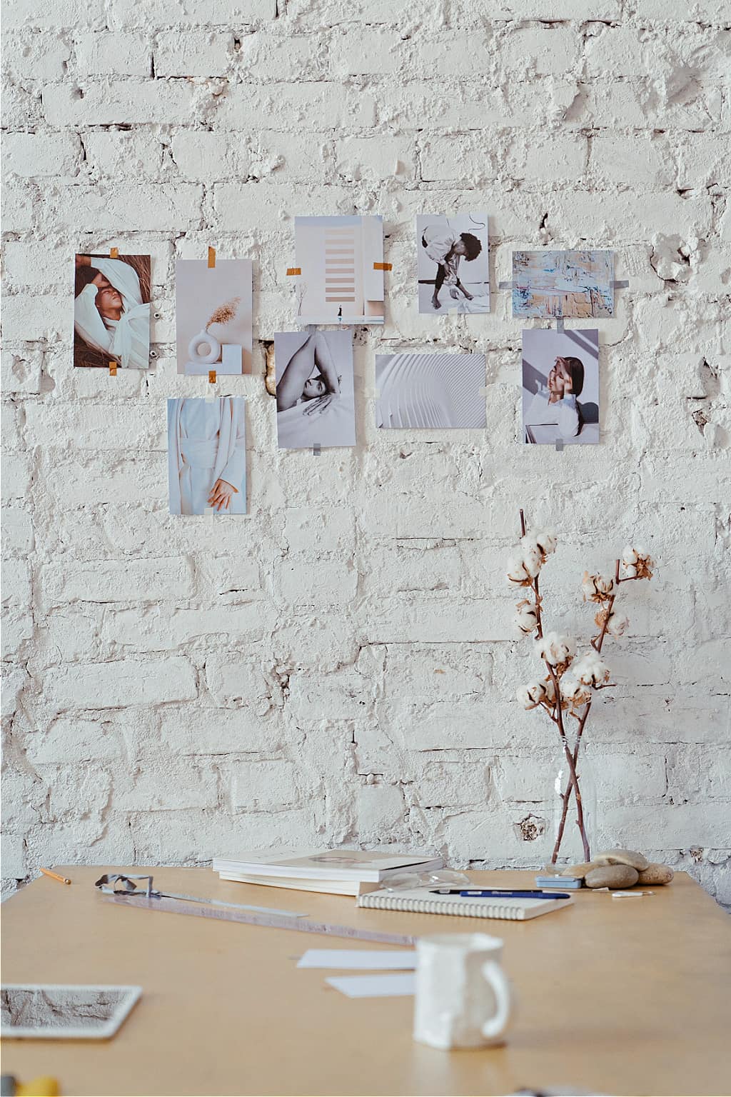 A pretty white mood board on a brick wall