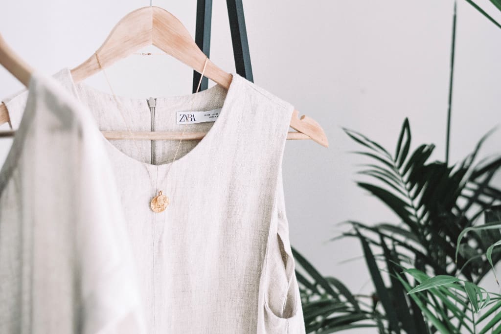A capsule wardrobe with white linen shirt hanging there