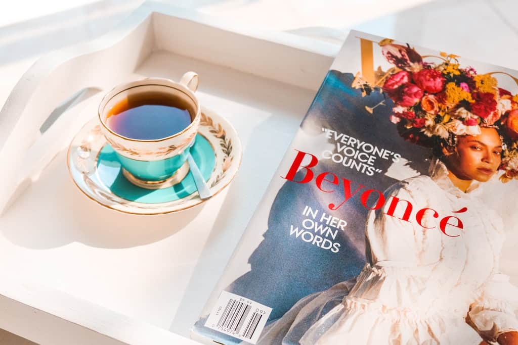 A cup of tea next to a magazine at a vision board party