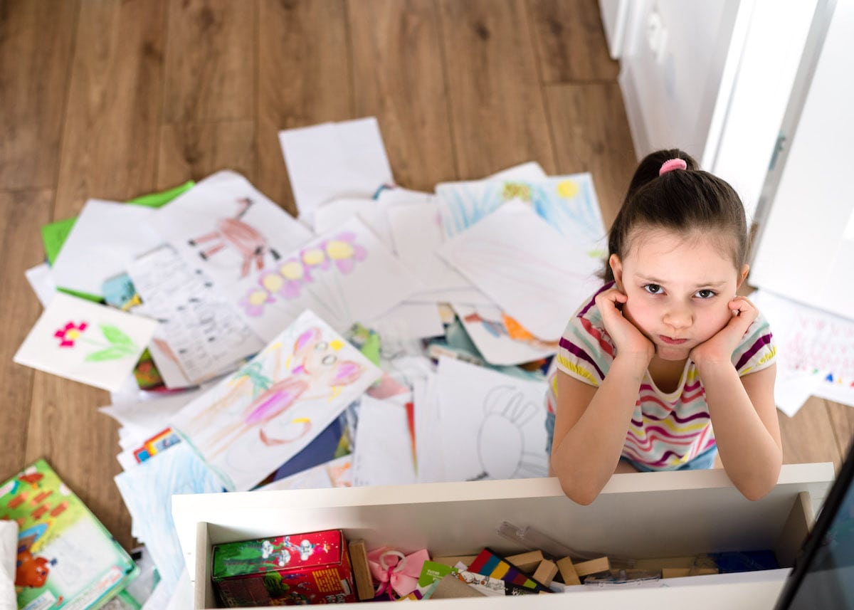 A child demonstrating KonMari kids decluttering on her artwork