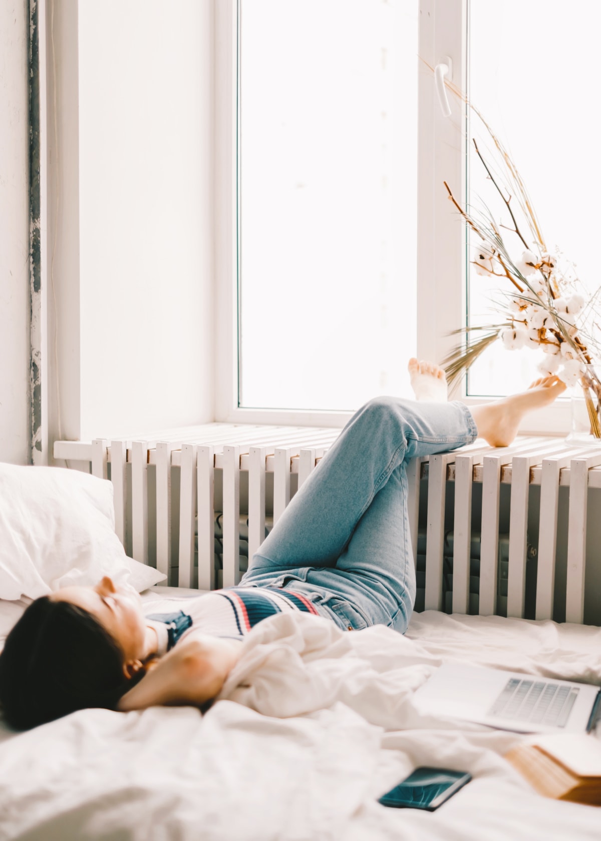 A woman relaxing after decluttering with the KonMari method