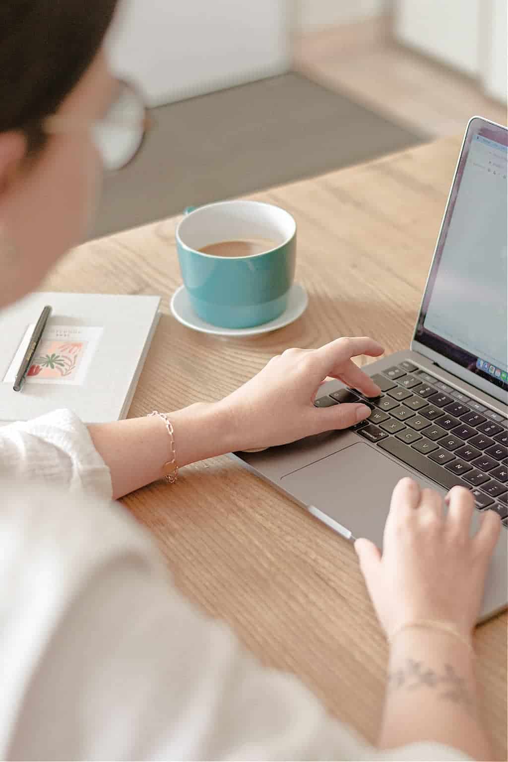 A woman writing a list of her best minimalist purchases