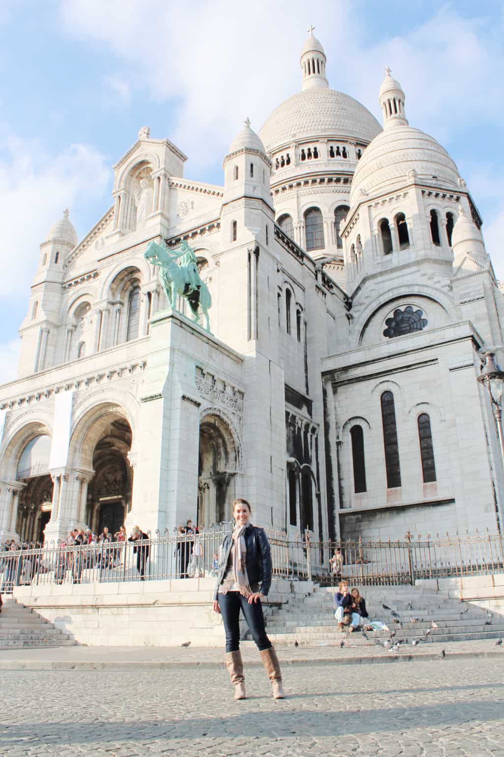 A woman standing in front of a church in Paris