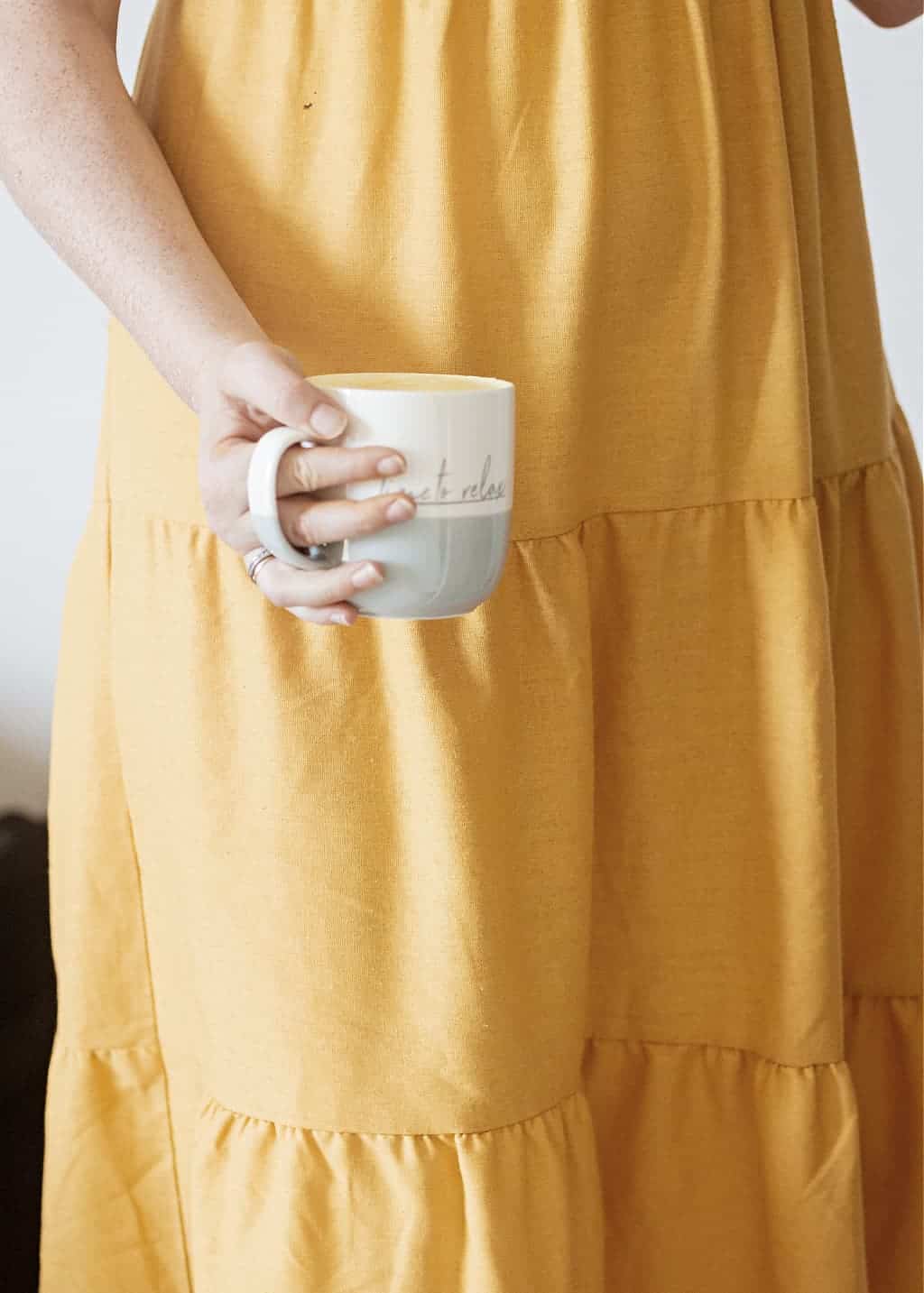 A woman wearing a yellow dress and studying how to simplify life