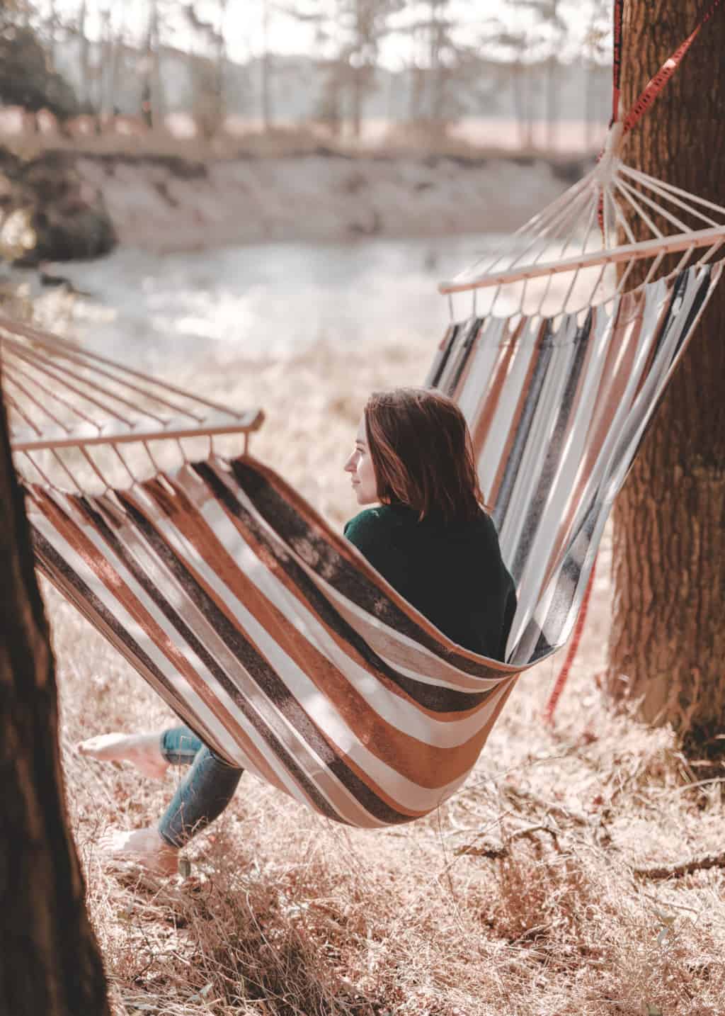 A woman living a simple life, relaxing in a hammock