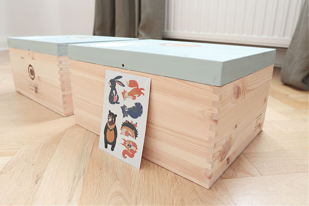 A close up of a child's memory box with paint and stickers