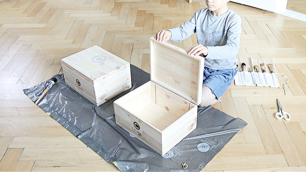 Boy holding his wood keepsake box open to decorate