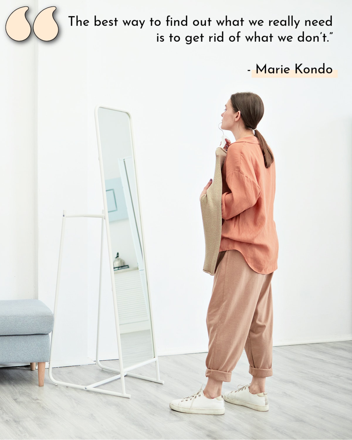A woman remembering a Marie Kondo declutter quote as she looks in a mirror