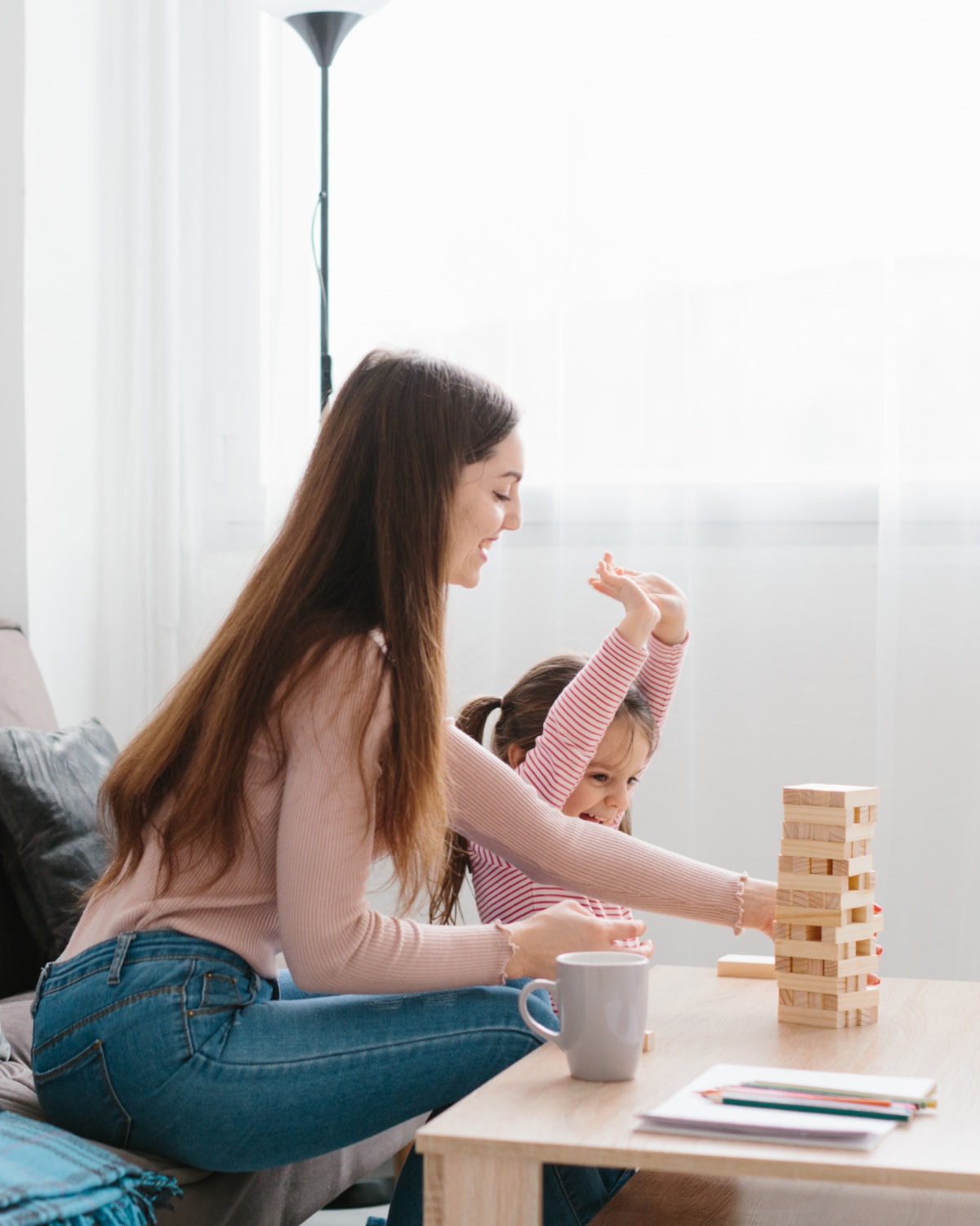 A woman showing her child how to declutter with the one in one out rule