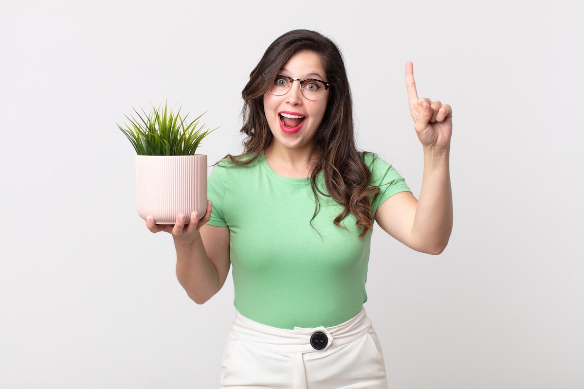 A woman demonstrating how to use the one in, one out rule of decluttering.