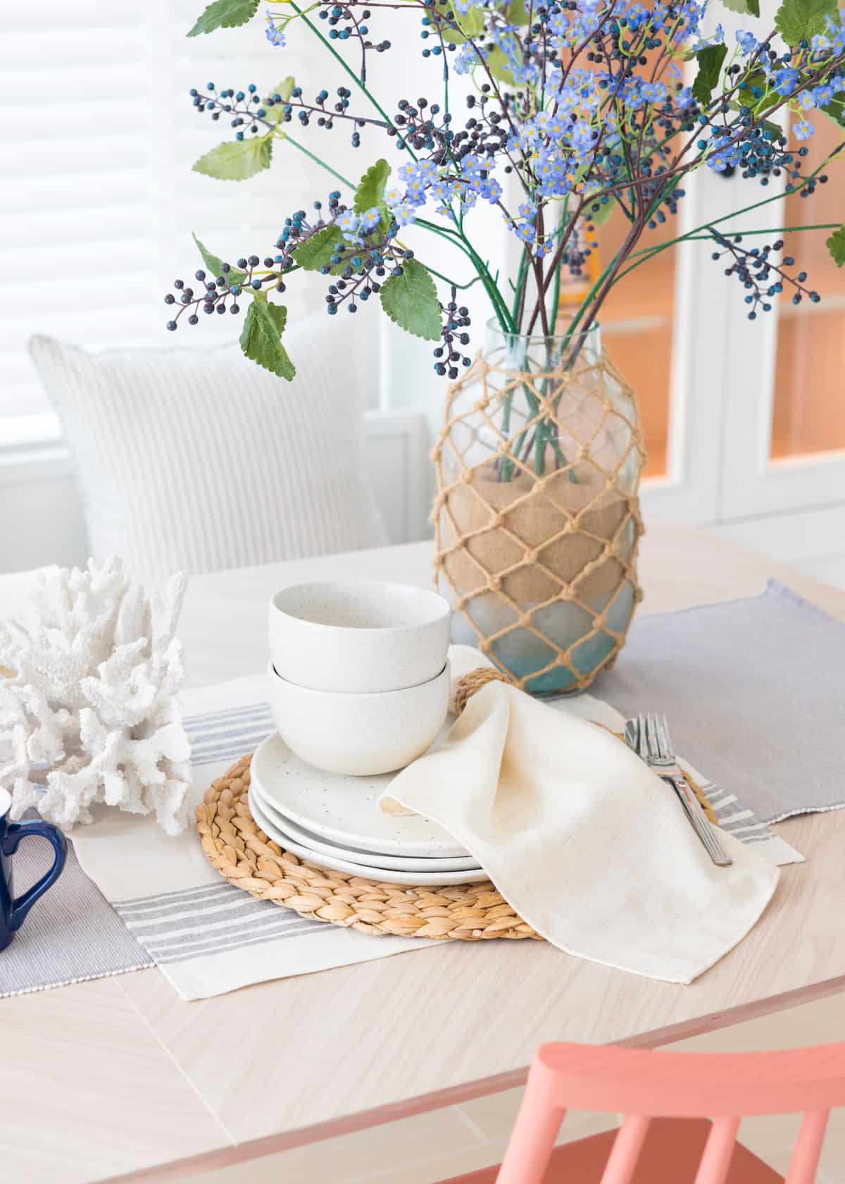 A simple life table setting with flowers and white plates