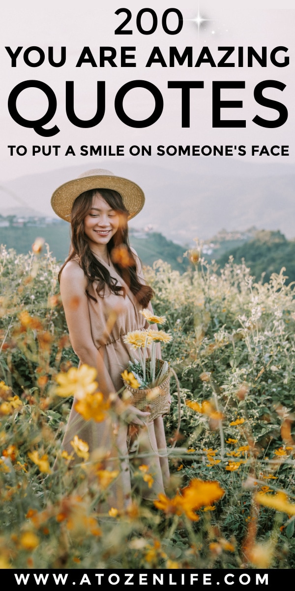 A woman smiling in a field of flowers after being told "you are amazing"