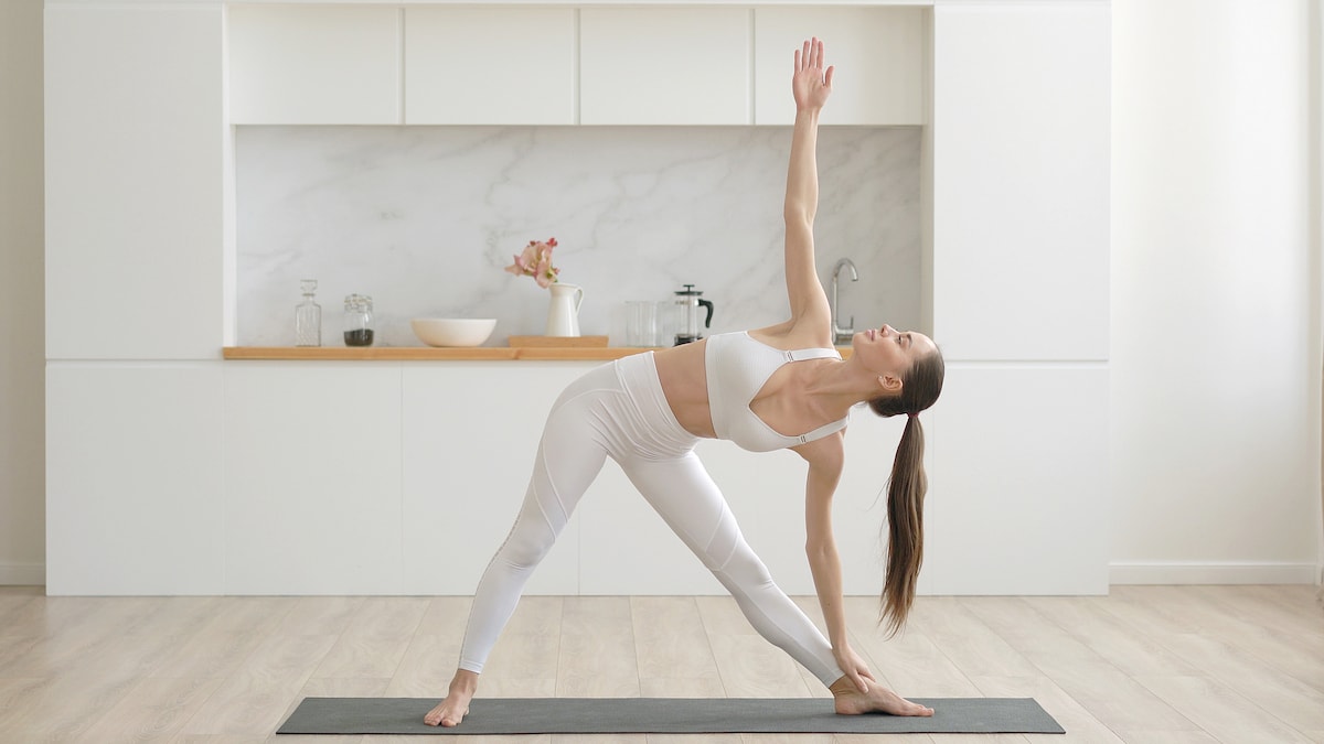 A woman in white yoga pants enjoying a relaxed and easier life by exercising