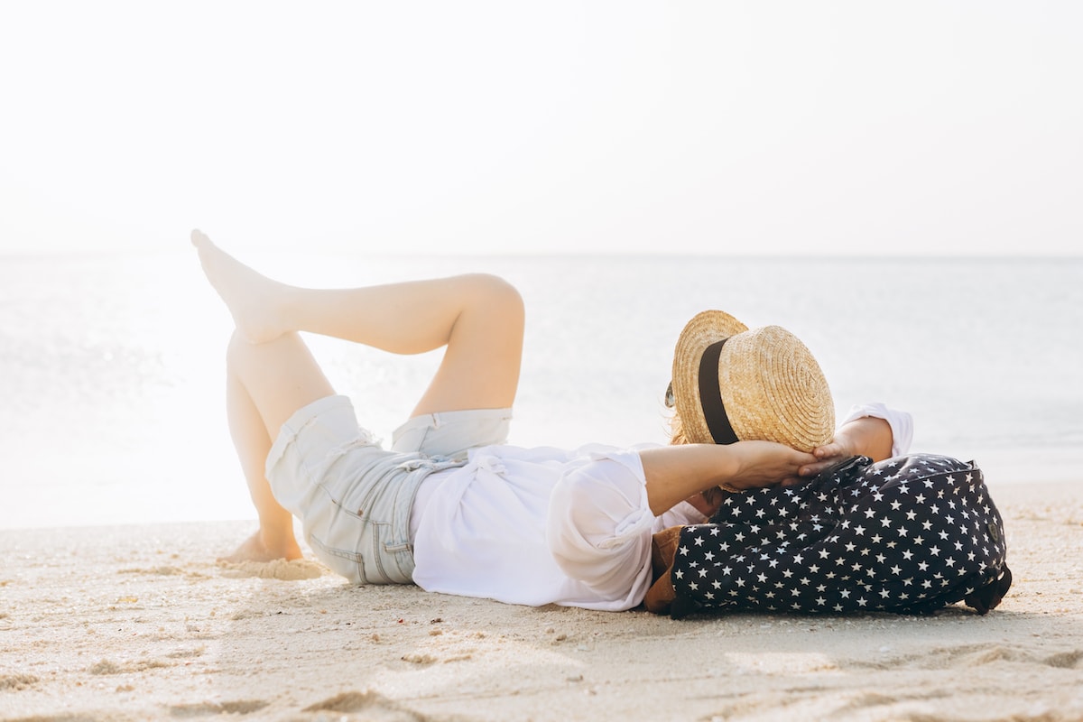 A woman making life easier by relaxing on the beach