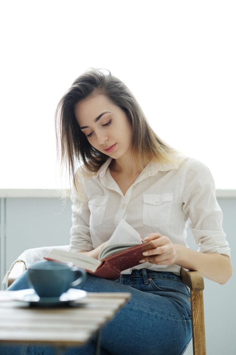 A woman reading the best decluttering books to declutter her home