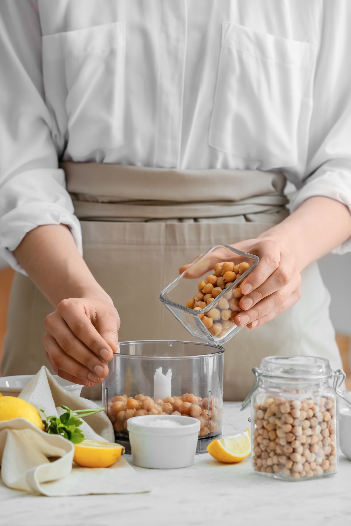 Close up of a woman's hands meal prepping food to be thrifty and save money on groceries