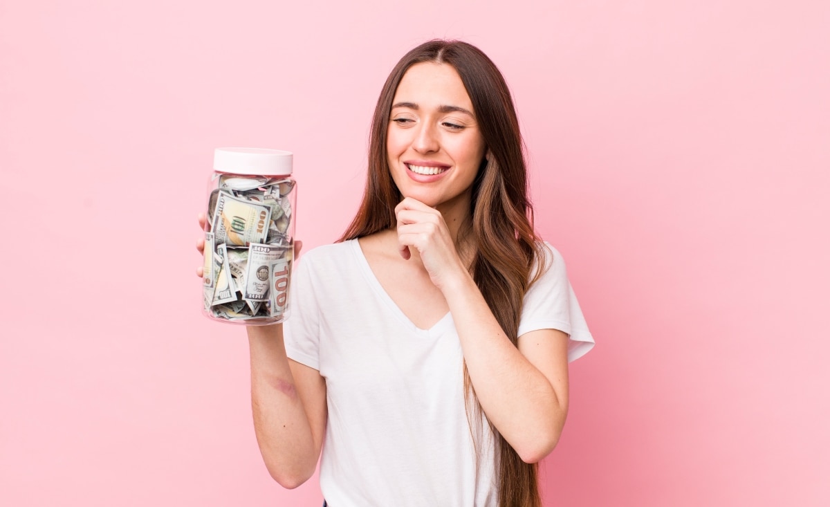 Financial minimalist women smiling pleased at her growing savings.