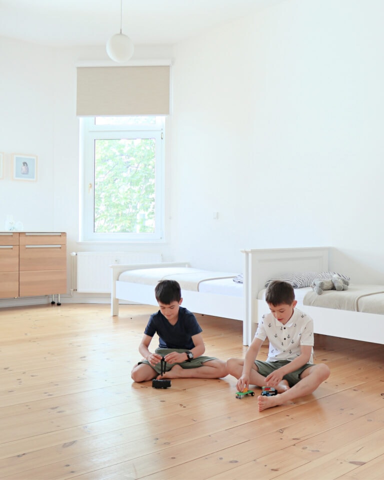 Kids from minimalist family playing in their bedroom