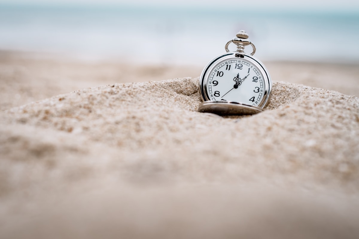 A pocket watch in the sand, measuring out the truth about the value of time