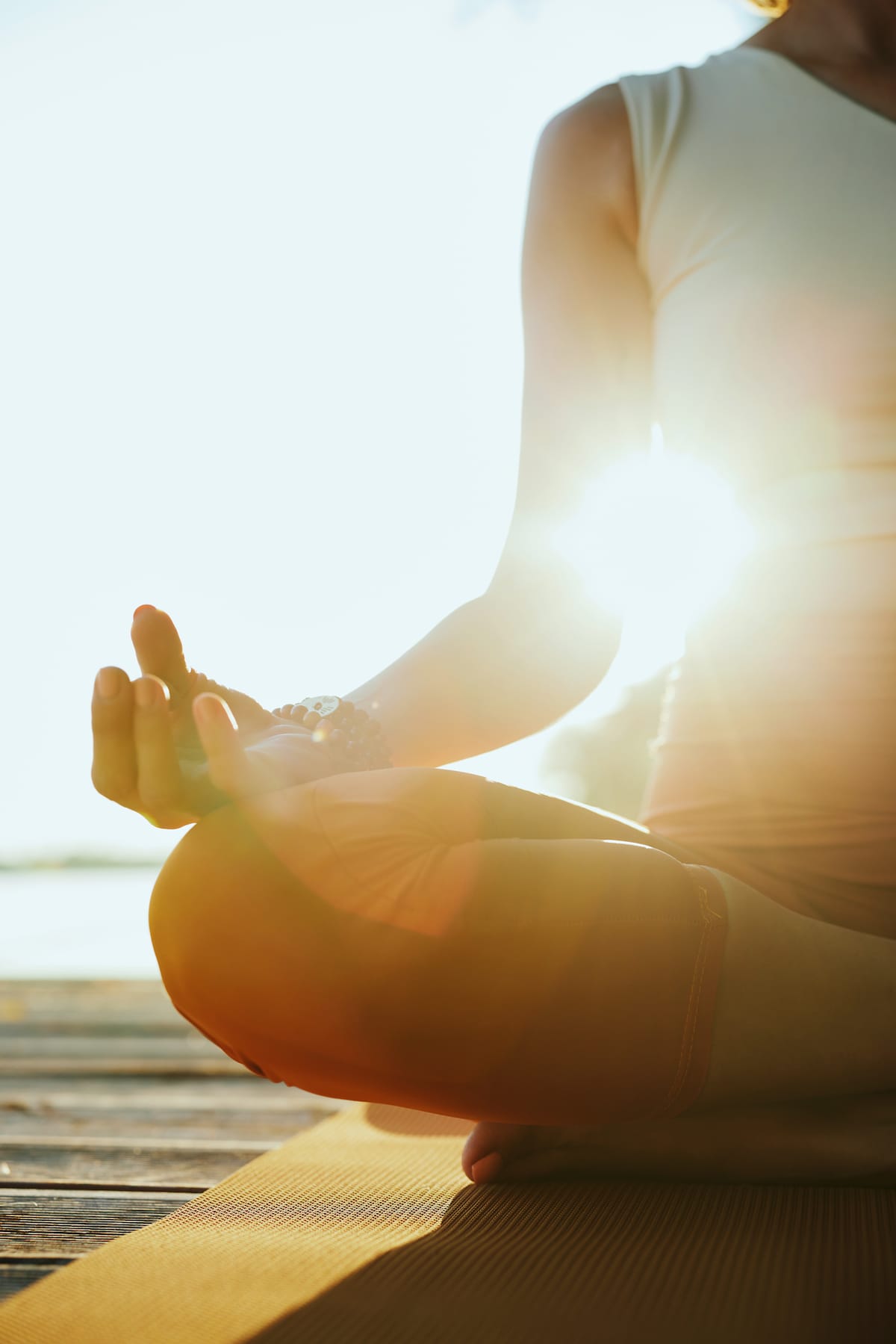 A woman meditating as a type of self-care for health and wellness